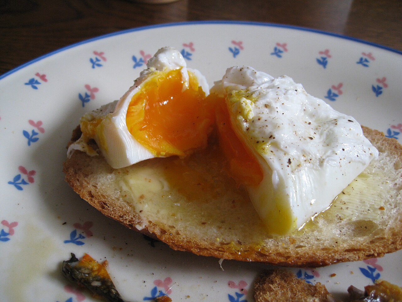 Poached egg on toast — white fully set, yolk domed and liquid