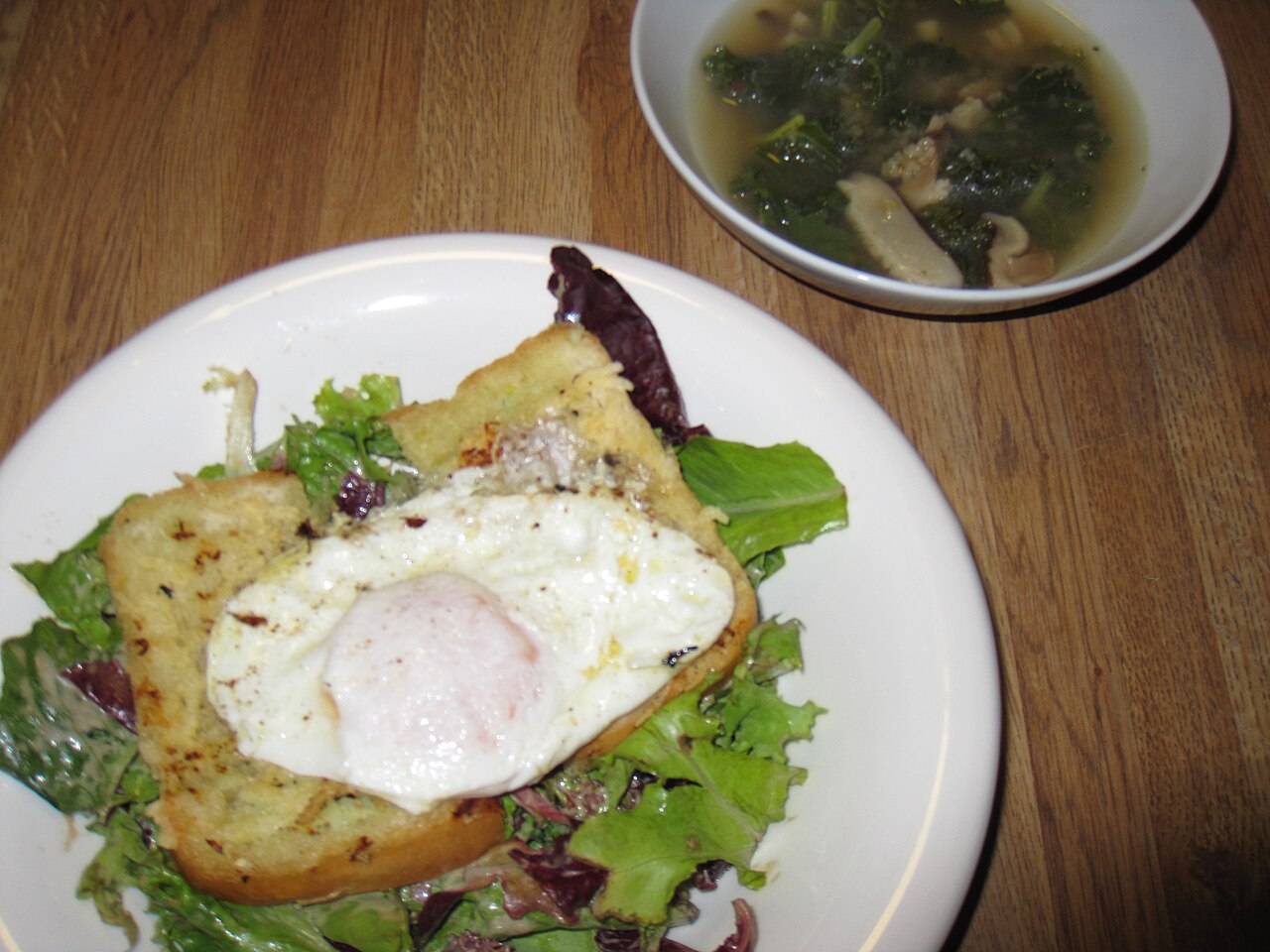 Poached egg over salad — clean white, runny yolk